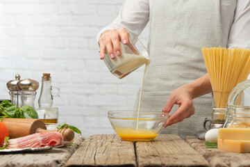 Chef prepares sauce for carbonara pasta Freeze in motion Kitchen Cooking and recipe book