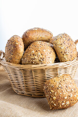 Home baked bread. Rye bakery with crusty loaves and crumbs. Fresh rustic traditional bread with wheat grain ear or spike plant on natural cotton background. Design element for bakery product label.