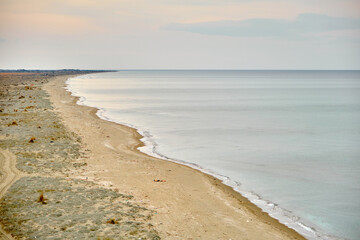Beach, shore of marmara sea in Mudanya and shore and huge sand empty beach during winter with overcast weather during sunset.