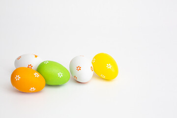 The minimal concept of Easter colour eggs. Stylish Easter eggs on a white background. The fashionable Easter lay flat. Happy Easter Greeting card with copy space for text
