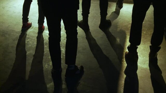 Close up shot of the shoes of the first people to attend a live music concert in a club in korea. Feet tapping and moving to the rhythm of the music.