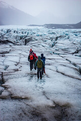 A Group of Hikers Uses Picks and Steel Spikes to Hike in the Rain on the Svínafellsjökull Glacier in Skaftafell National Park, Iceland