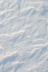 Fresh clean white snow background texture. Winter background with snowflakes and snow mounds. Snow lumps. Seasonal landscape details.