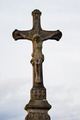 Old stone cross with Jesus.