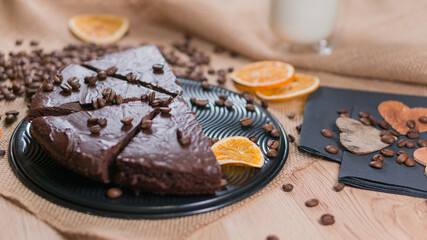 slices of chocolate brownie cake with glass of milk and coffee beanas on wooden table