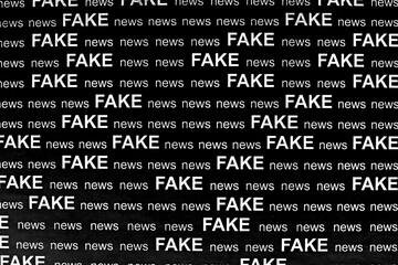 fake news printed background in black and white image. white text on black paper. flat lay