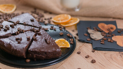 slices of chocolate brownie cake with glass of milk and coffee beanas on wooden table