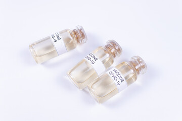 three ampoules with the Covid-19 vaccine lie in parallel
