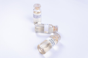 two ampoules with the Covid-19 vaccine lie and one stands side by side