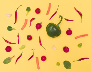 Flat lay arrangement of different vegetables in size and colors. Flay lay on yellow background.