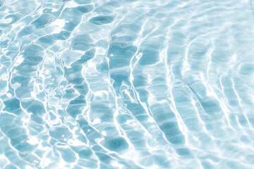 Blue water surface with bright sun light reflections, water in swimming pool background. 