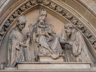 Fototapeta na wymiar Relief of Madonna and Child Jesus and saints
