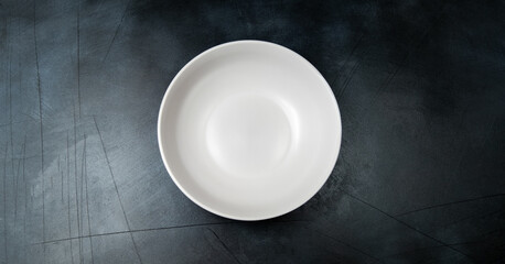 White craft plate on dark stone table. Top view, copy space, Table setting. background for menu, layout, place for text , recipe background