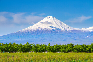 Fototapeta premium Mount Ararat (Turkey) at 5,137 m viewed from Yerevan, Armenia. This snow-capped dormant compound volcano consists of two major volcanic cones described in the Bible as the resting place of Noah's Ark.