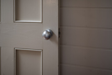 Beige door with silver knob inside cottage 