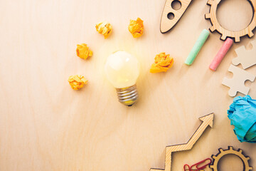 light bulb with papers and stationary