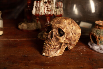 Halloween background Shelves with alchemy tools Skull spiderweb bottle with poison candles
