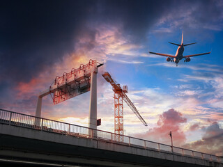 Highway and feeder road at the airport to the air cargo transport center with airplane port. 