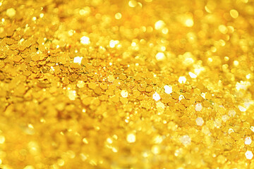 Gold defocused glitter.  Bokeh light of gold glitters background. 