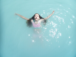 Girl swimming in a thermal bath, Bagni di Tivoli, Lazio, Italy