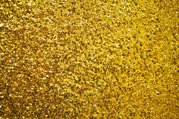 Gold defocused glitter.  Bokeh light of gold glitters background. 