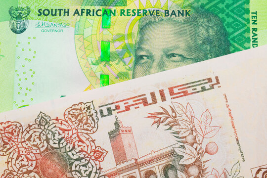 A macro image of a shiny, green 10 rand bill from South Africa paired up with a beige 200 Algerian dinar bank note.  Shot close up in macro.