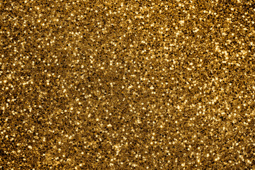 Gold defocused glitter.  Bokeh light of gold glitters background. 