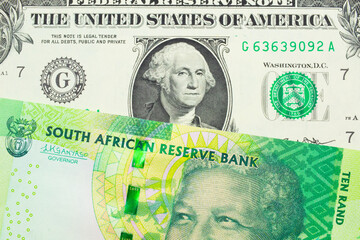 A macro image of a shiny, green 10 rand bill from South Africa paired up with a green one dollar bill from the United States.  Shot close up in macro.