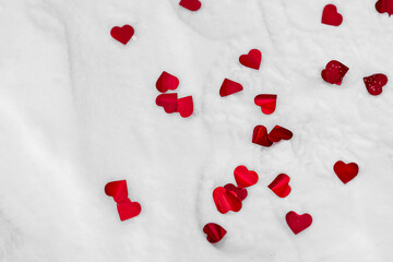 red hearts on snow background