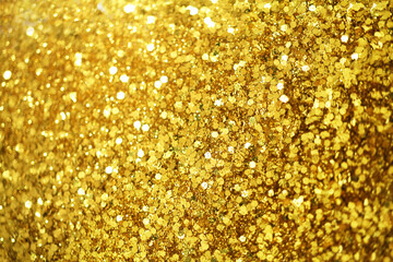 Gold defocused glitter.  Bokeh light of gold glitters background. 