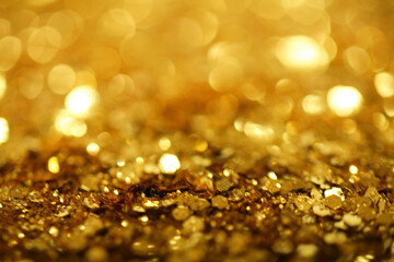 Gold defocused glitter.  Bokeh light of gold glitters background. 