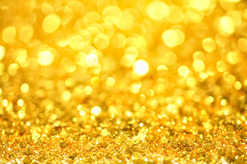 Gold defocused glitter.  Bokeh light of gold glitters background. 