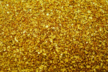 Gold defocused glitter.  Bokeh light of gold glitters background. 