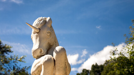 Unicorn rearing up, a garden sculpture with copy space.