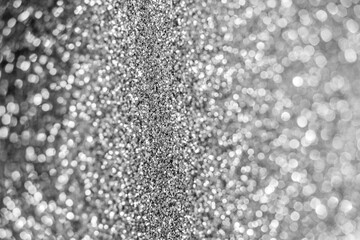 Silver defocused glitter.  Bokeh light of gold glitters background. 