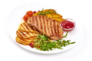 Grilled beef steak with potato wedges, grilled pears and arugula salad, isolated on white background
