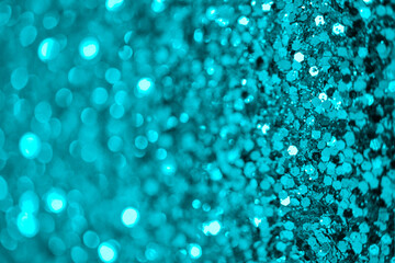 Teal  defocused glitter.  Bokeh light of gold glitters background. 