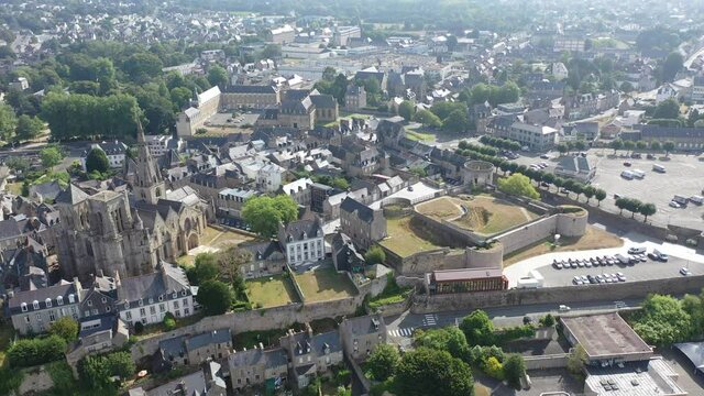 Flight over the city Guingamp and Basilica of Our Lady of Merciful on summer day. France
