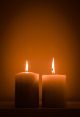 still-life with two burning candles