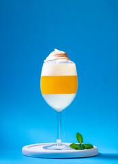 Italian dessert panna cotta with tangerine jelly layer in a glass