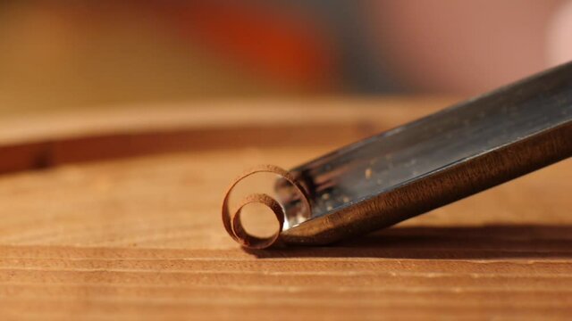 woodcarver cuts mahogany with a chisel macro. contains sound ASMR
