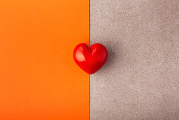 Red heart on orange and grey background