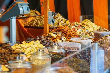 different types of dried fruits and nuts at colorful market stall