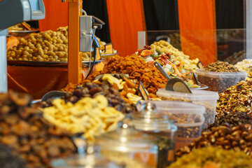 different types of dried fruits and nuts at colorful market stall