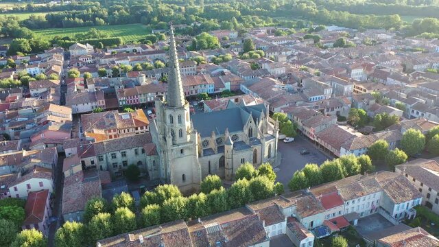 View from drone of houses of Mirepoix town and cathedral of St-Maurice at sunny summer day, France