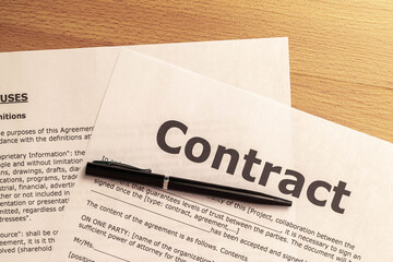 detail of a drafted contract ready to be filled out and signed by a customer on a wooden table