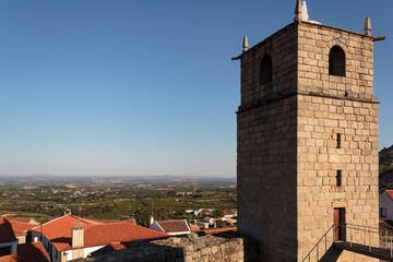 Castle bell tower with village in the background