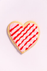 close up of a homemade heart shaped valentines sugar cookie with colorful icing