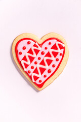 close up of a homemade heart shaped valentines sugar cookie with colorful icing