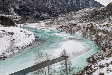 Partly frozen turquoise river Chuya in winter, Altai Republic, Russia